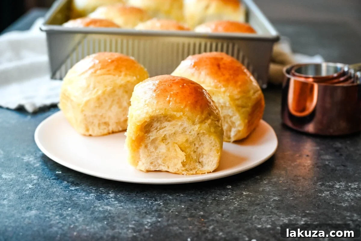 Pillowy Japanese Milk Buns 9 A selection of freshly baked Japanese milk bread dinner rolls, showcasing their signature soft, fluffy, and tender qualities, achieved through the special tangzhong method. Perfect for any meal.
