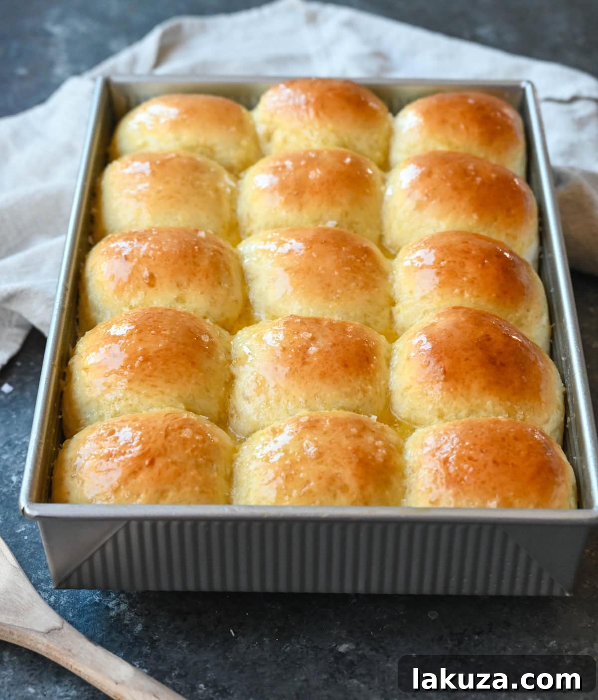 Pillowy Japanese Milk Buns 3 Close-up of freshly baked Japanese Milk Bread Dinner Rolls, highlighting their soft, fluffy texture and golden-brown crust. Made using the tangzhong method for ultimate tenderness.