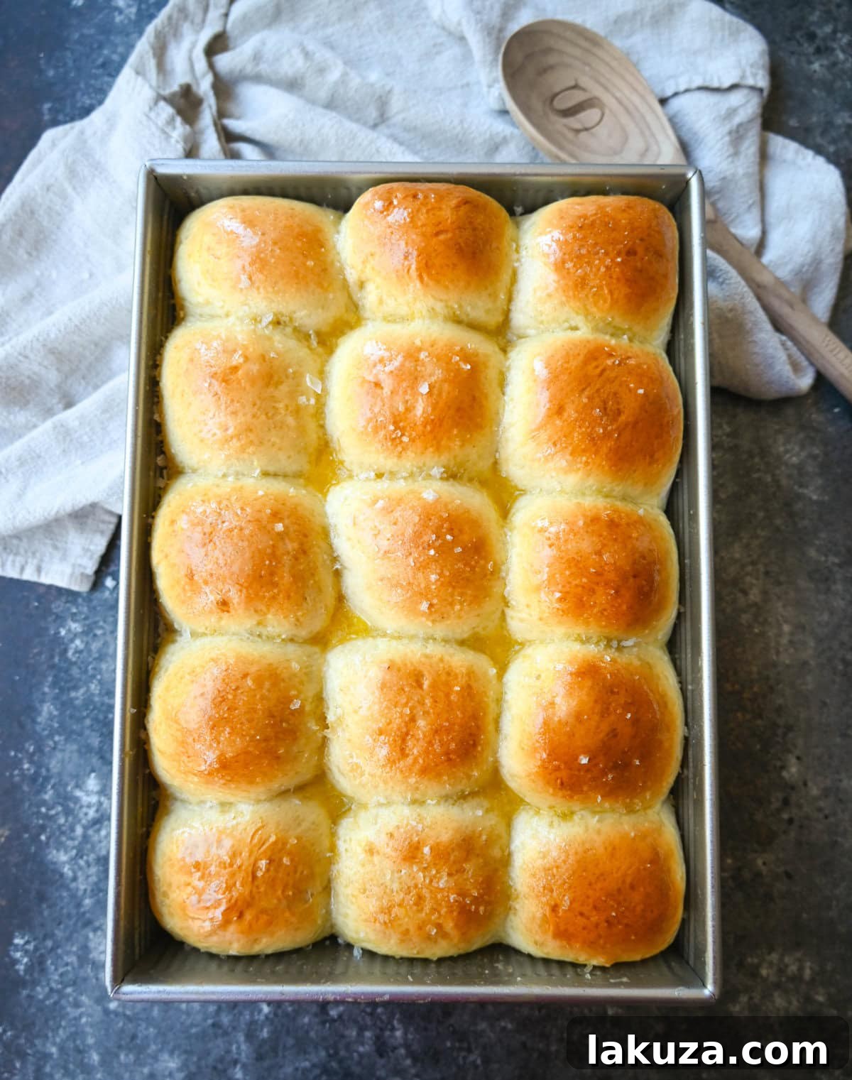 Pillowy Japanese Milk Buns 8 Warm Japanese Milk Bread Dinner Rolls baked to golden perfection in a 9x13 inch pan, ready to be served. Their soft, fluffy texture is a hallmark of the tangzhong method.