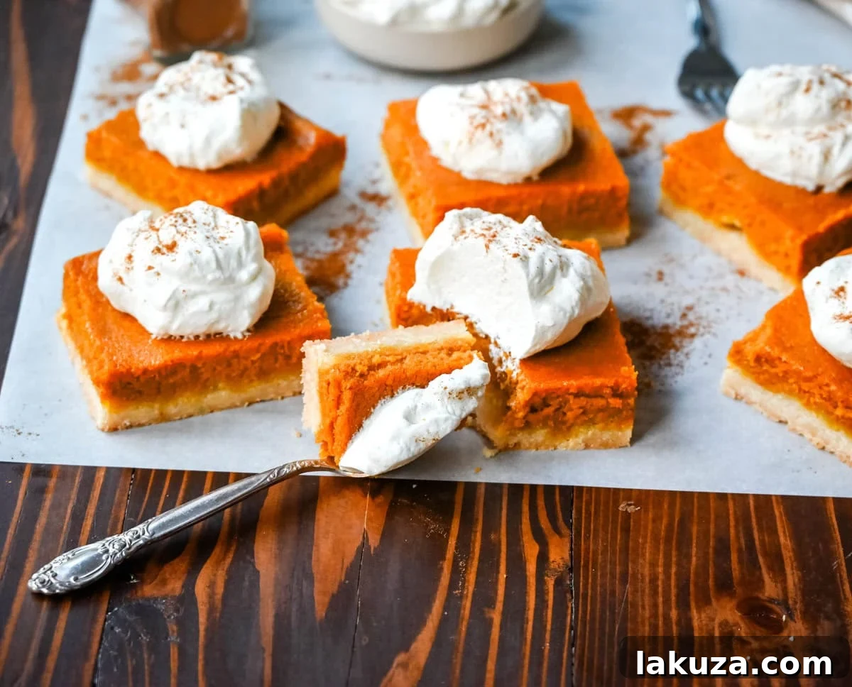 The smooth, orange pumpkin cream cheese filling is shown in a mixing bowl, ready to be poured over the baked shortbread crust.