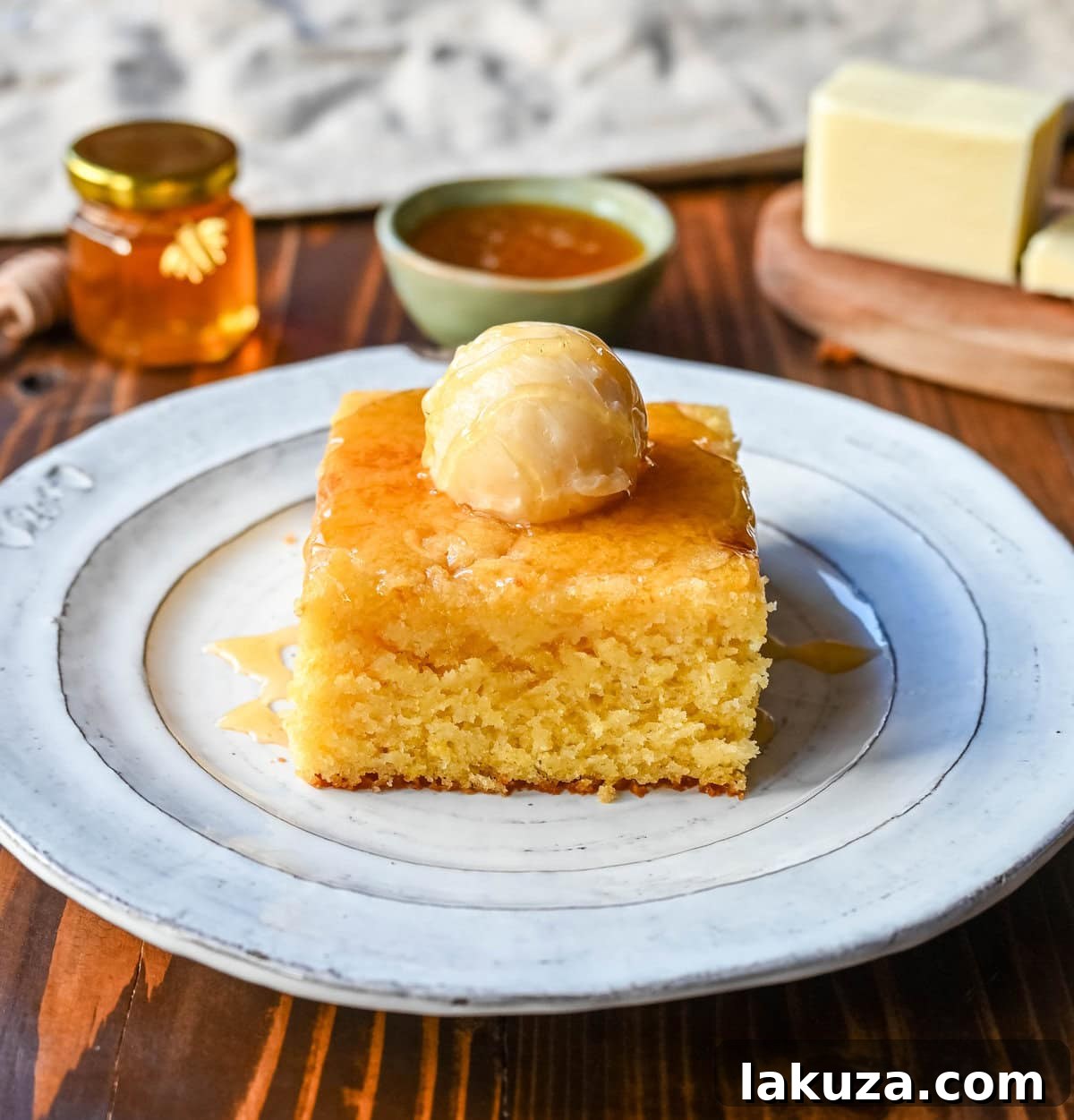 Southern Soul Cornbread 2 A perfectly golden-brown, moist cornbread, ready to be sliced, promising tenderness and rich flavor.