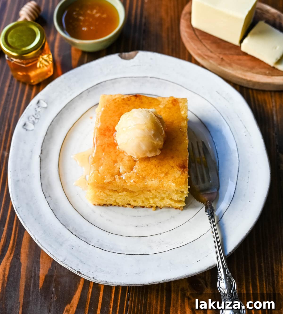 Southern Soul Cornbread 4 Freshly baked cornbread cooling in a square baking dish, revealing its golden-brown crust and inviting texture.