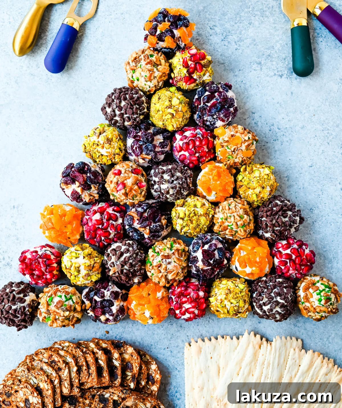 Irresistible Mini Cheese Bites 4 A close-up of three mini cheese balls, each rolled in a different coating—nuts, herbs, and dried fruit—showcasing their customizable nature.