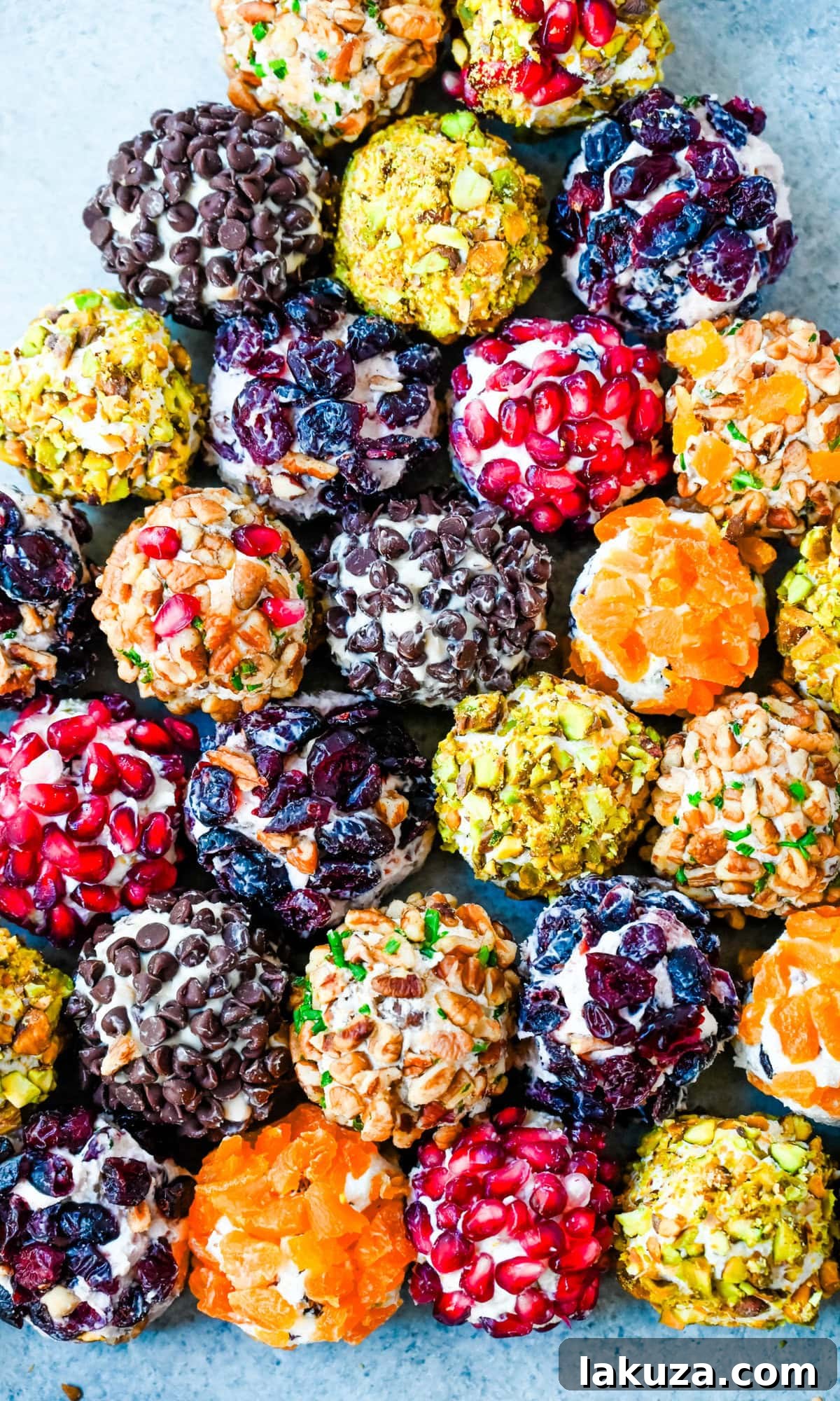 Irresistible Mini Cheese Bites 7 A vibrant selection of mini cheese balls, both savory and sweet, presented as a perfect holiday appetizer on a tiered serving tray.