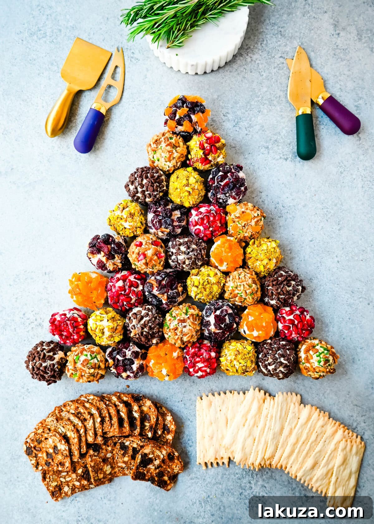 Irresistible Mini Cheese Bites 8 A festive Christmas tree shaped display made from an arrangement of mini cheese balls, garnished with rosemary and a star topper.