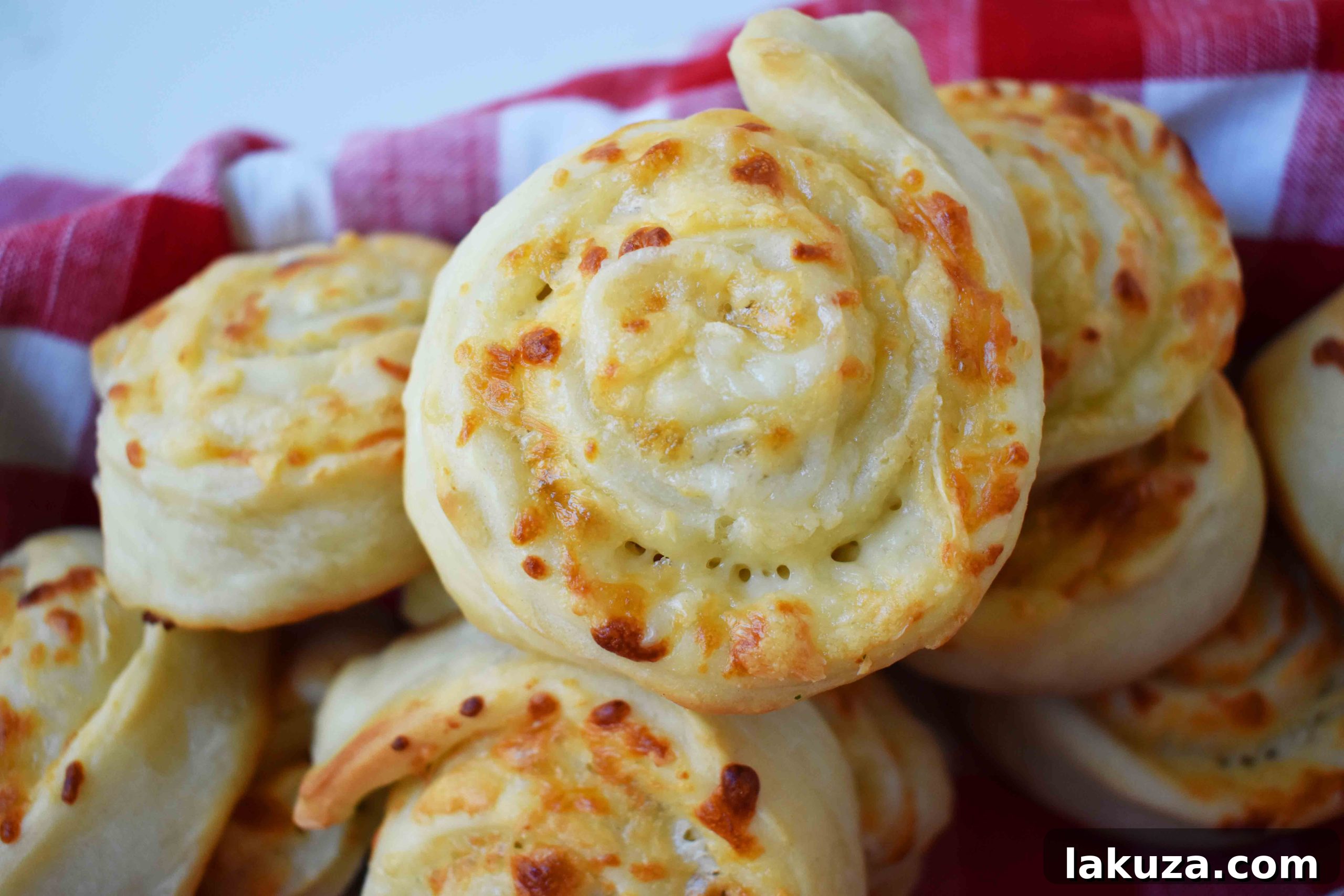 Golden's Savory Garlic Parmesan Cheese Rolls 3 Freshly baked garlic parmesan cheese rolls with melted cheese, ready to serve.