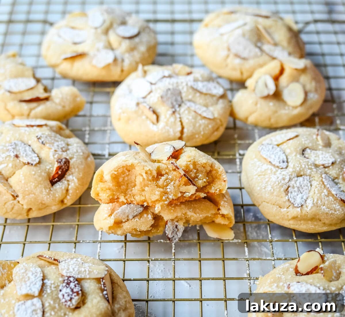 Almond Croissant-Inspired Cookies 3 Close-up of baked Almond Croissant Cookies, dusted with powdered sugar, highlighting their enticing texture.