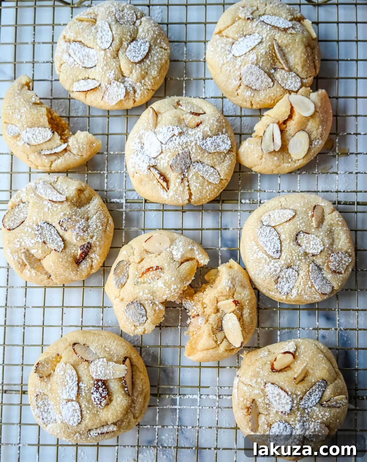 Almond Croissant-Inspired Cookies 4 Stack of freshly baked Almond Croissant Cookies with a generous dusting of powdered sugar, ready to be enjoyed.