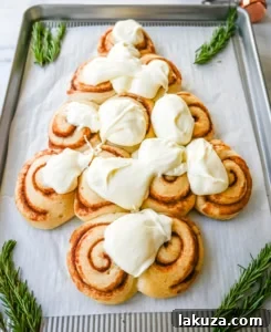 Frost the Cinnamon Roll Christmas Tree with frosting.