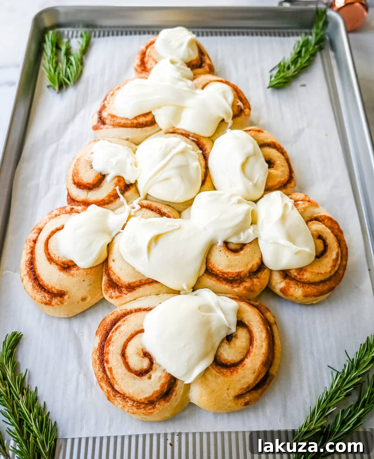 Frost the Cinnamon Roll Christmas Tree with frosting.