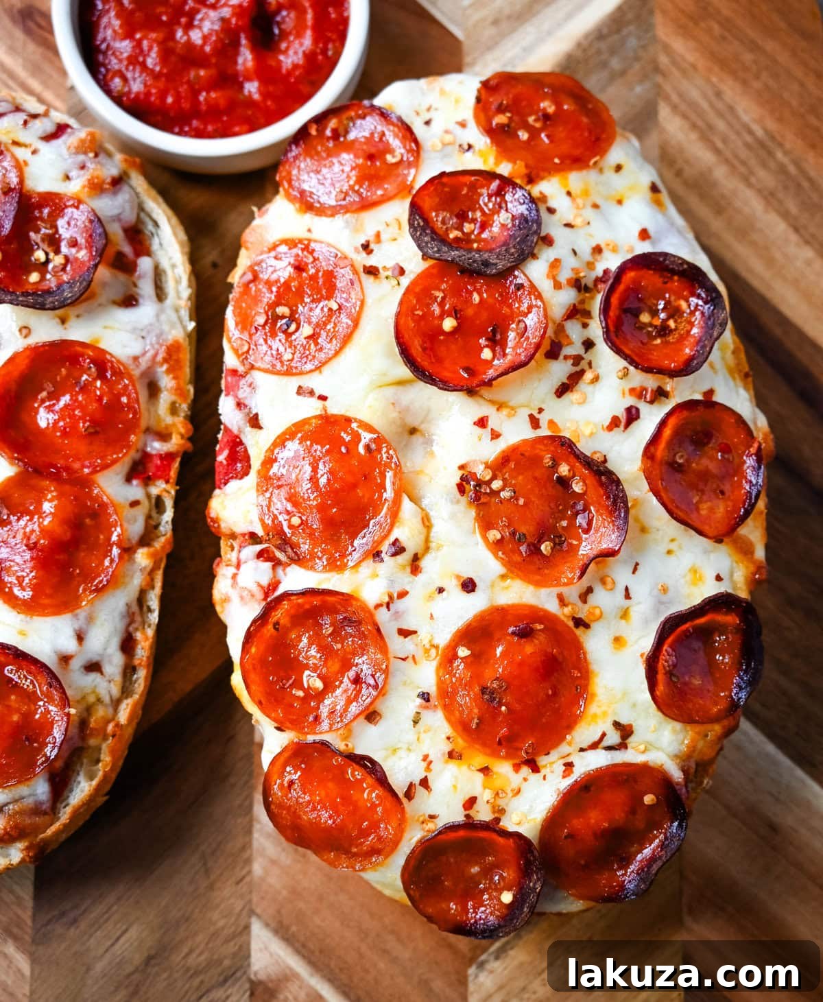 Crispy French Bread Pizzas 3 Close-up of a freshly baked French bread pizza with bubbling mozzarella and crispy pepperoni slices.