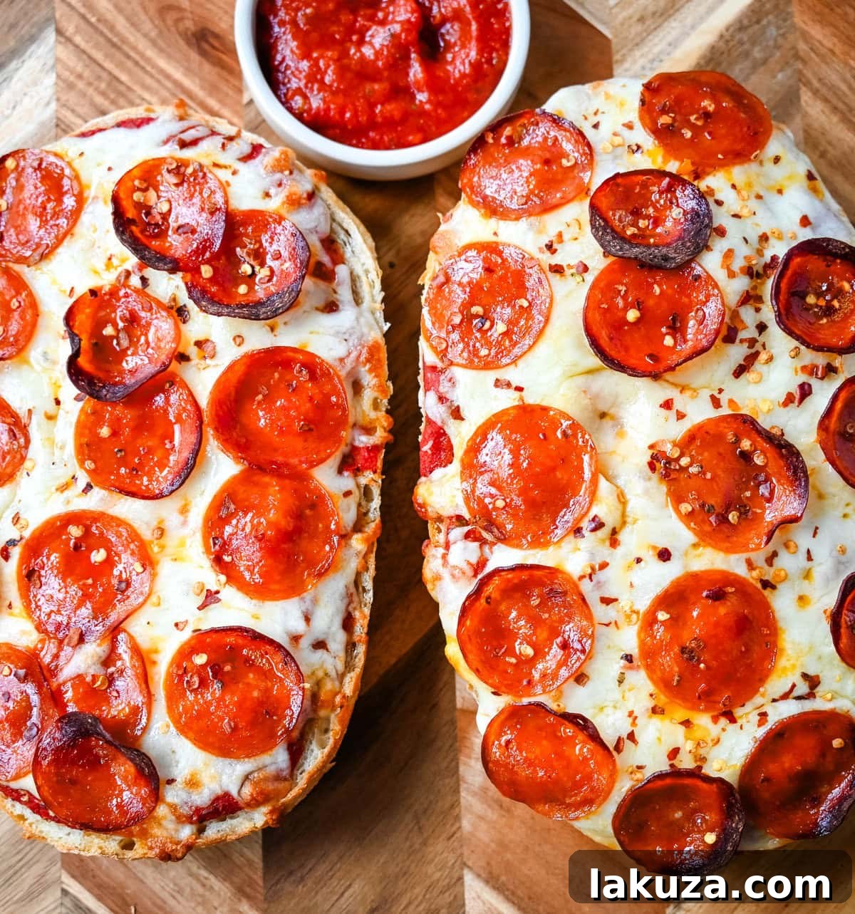 Crispy French Bread Pizzas 6 A complete French bread pizza, garnished with fresh herbs and red pepper flakes, ready to be served.