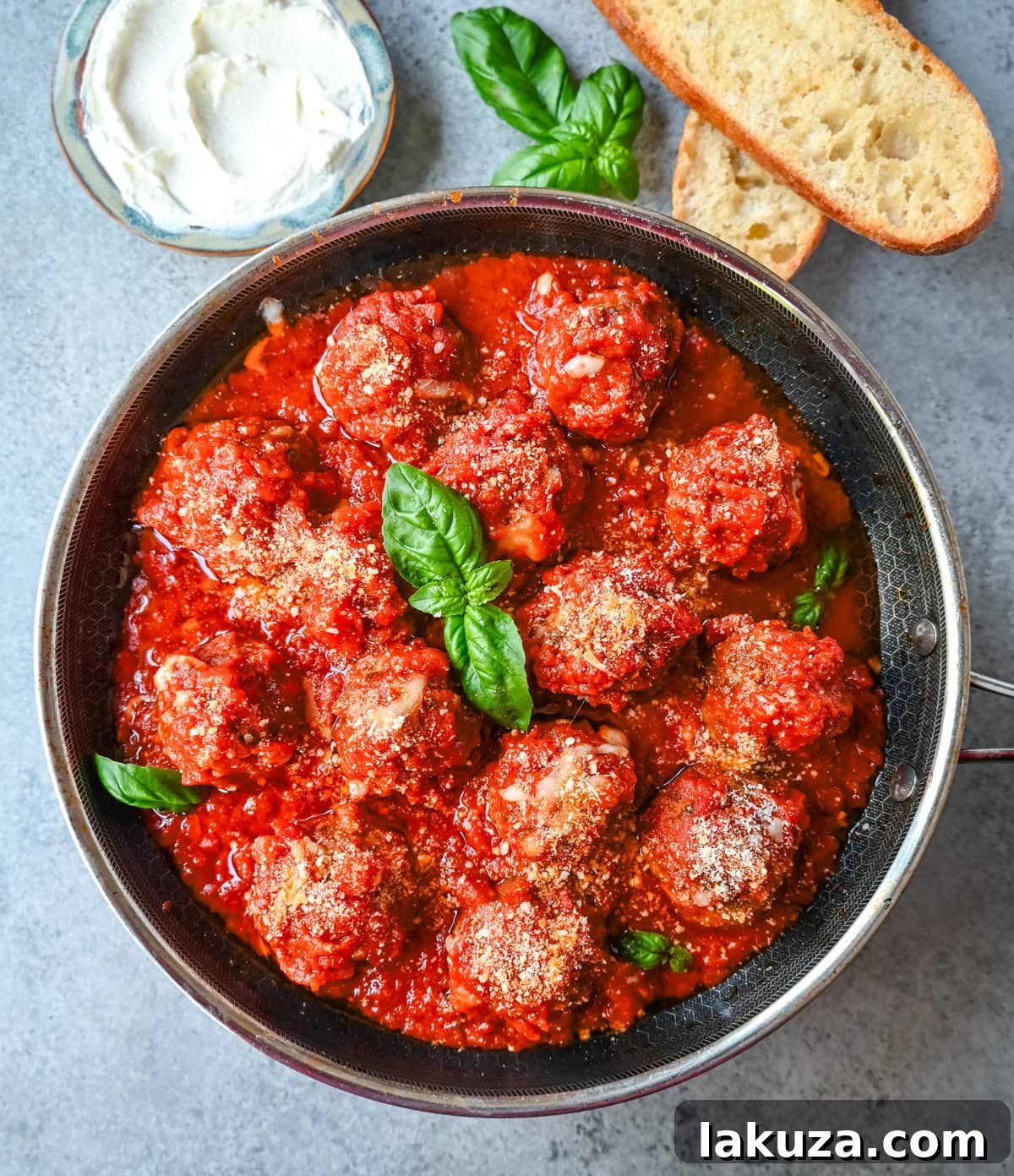 Close-up of baked Ricotta Parmesan Meatballs in a skillet before adding marinara, showing their golden brown exterior.
