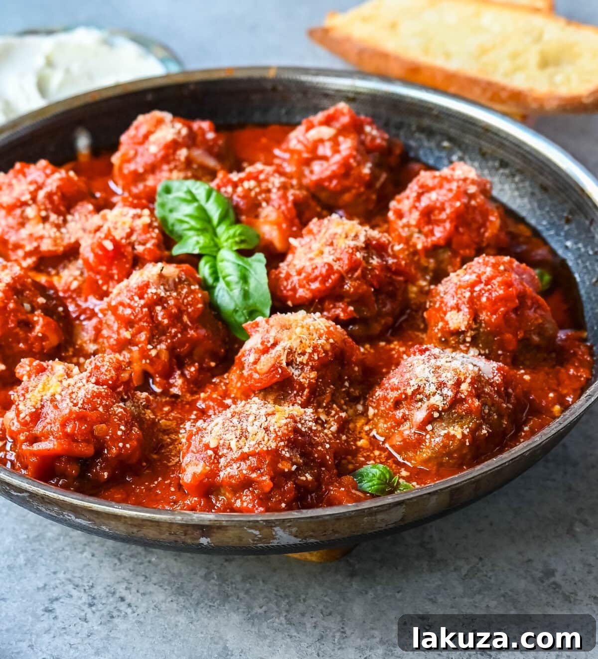 Ricotta Parmesan Meatballs garnished with fresh basil and grated Parmesan cheese, ready to be served.