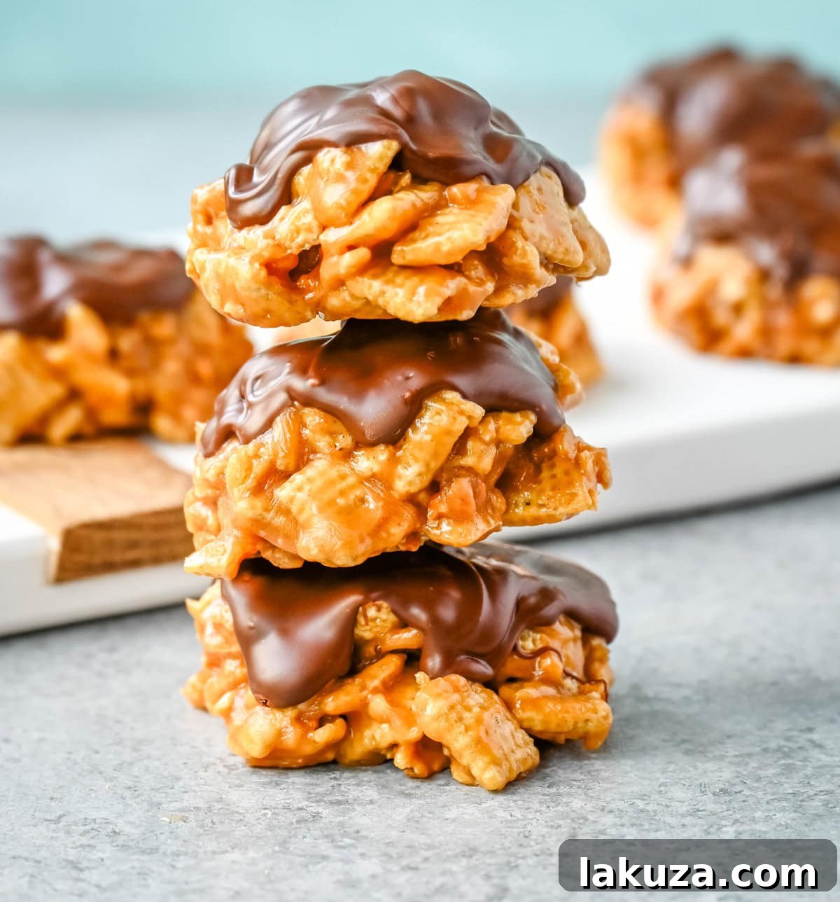 Butterscotch Peanut Chex Bliss 4 Three perfectly formed Chex Scotcheroos, glistening with their chocolate and butterscotch topping, ready to be enjoyed.