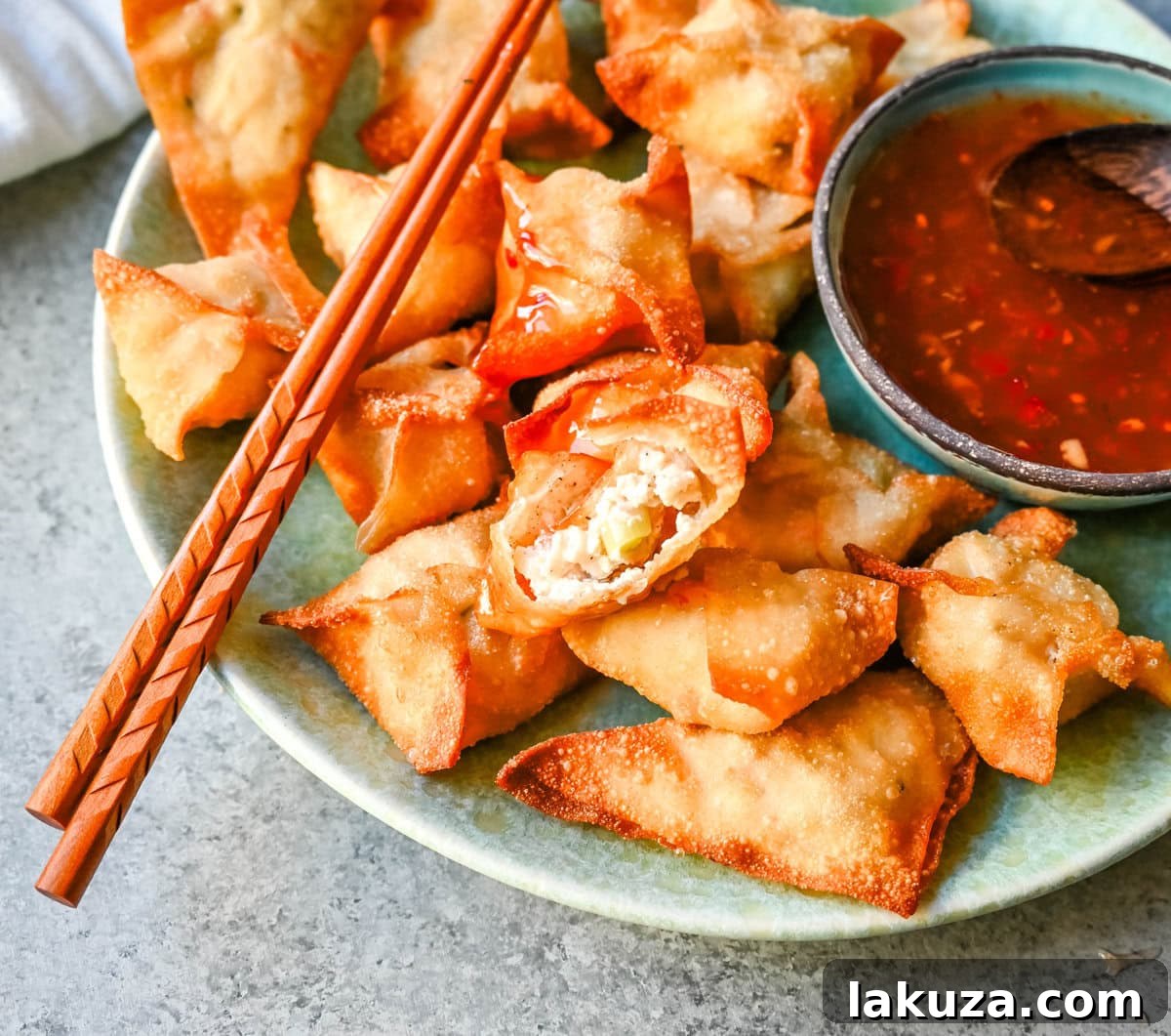 Close-up of crispy Crab Rangoon, a Chinese restaurant favorite, filled with a creamy, savory crab and cream cheese mixture.