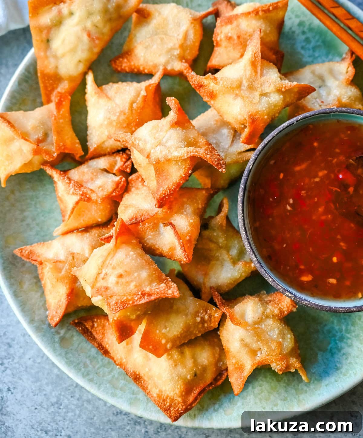 Ingredients for making homemade Crab Rangoon, including cream cheese, crab meat, green onions, and wonton wrappers.