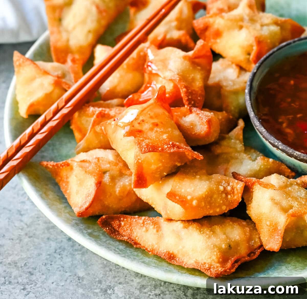 A plate of freshly made Crab Rangoons, showing their delicious golden crisp exterior and ready to be served.