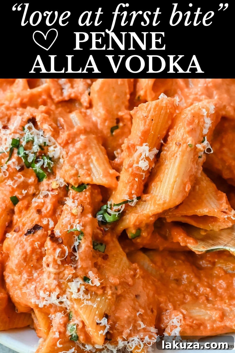 A stunning top-down view of Penne alla Vodka, generously garnished with fresh basil leaves and grated Parmesan, ready for a delicious meal.