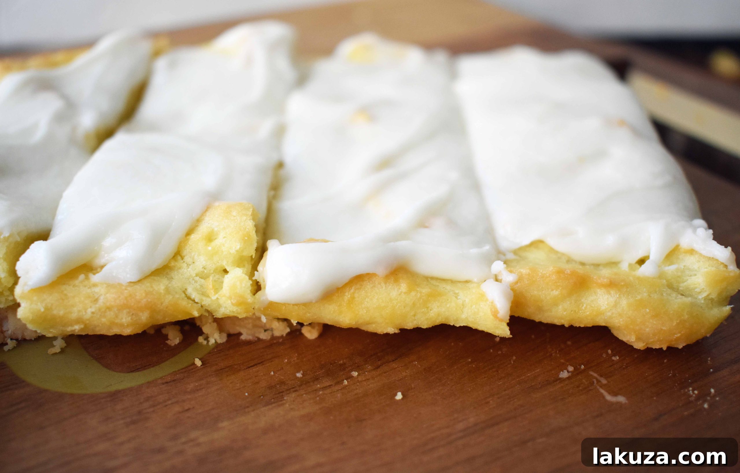 Swedish Pastry by Modern Honey. Buttery flaky layers with almond filling and topped with sweet cream frosting. A popular homemade European pastry. 