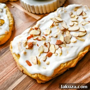 This homemade Swedish Pastry, also known as Danish Kringle, features a buttery crust, an almond filling, and topped with an almond frosting. This buttery pastry is buttery, creamy, and has just the right sweetness. A holiday tradition!