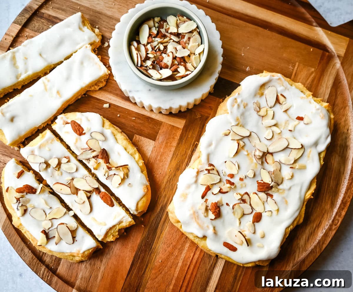 This homemade Swedish Pastry, also known as Danish Kringle, features a buttery crust, an almond filling, and topped with an almond frosting. This buttery pastry is buttery, creamy, and has just the right sweetness. A holiday tradition!