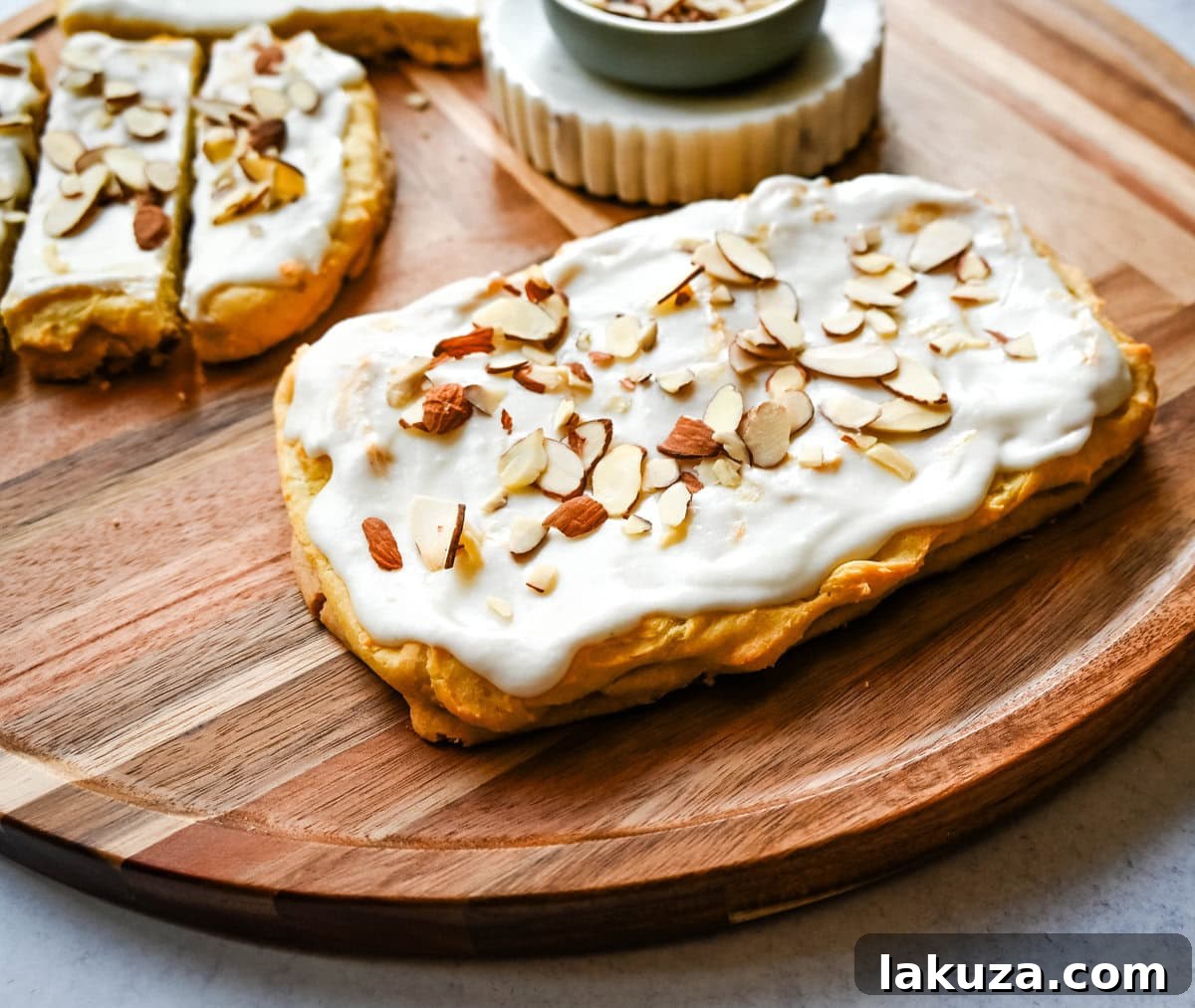 This homemade Swedish Pastry, also known as Danish Kringle, features a buttery crust, an almond filling, and topped with an almond frosting. This buttery pastry is buttery, creamy, and has just the right sweetness. A holiday tradition!