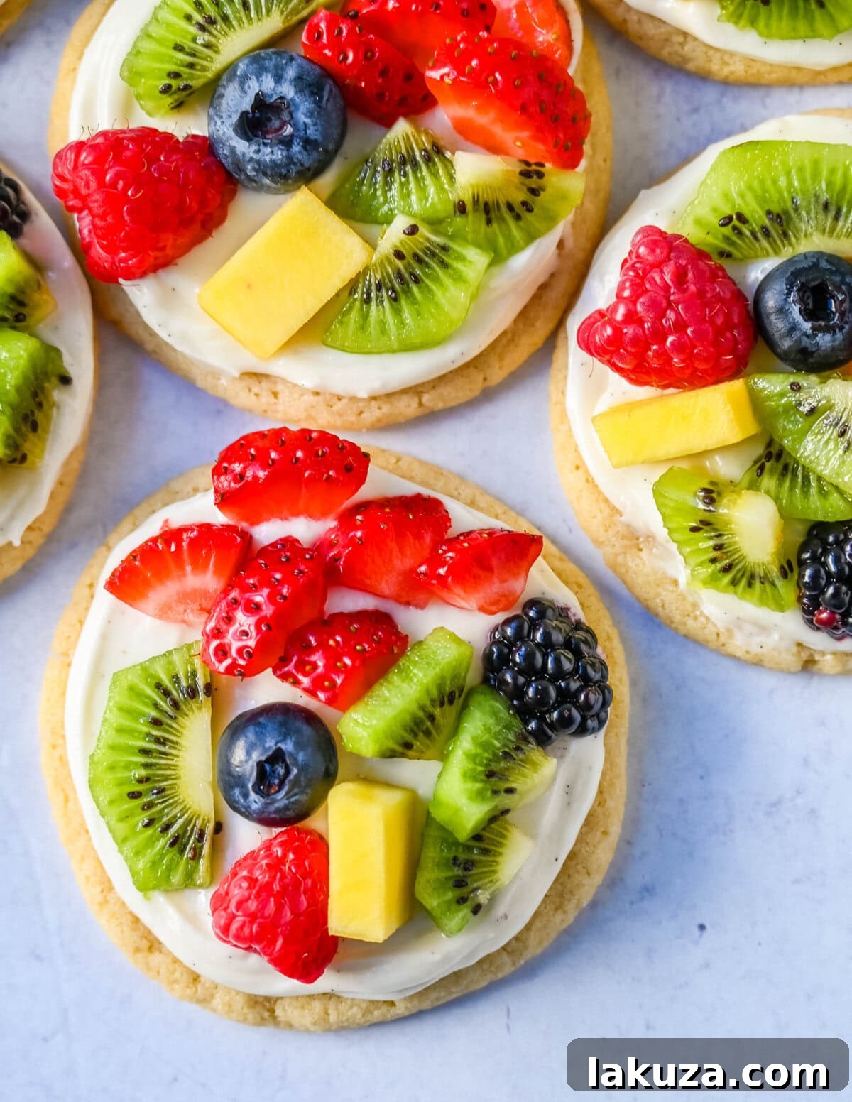 A vibrant selection of Fruit Pizza Cookies on a white serving platter, ready for guests.