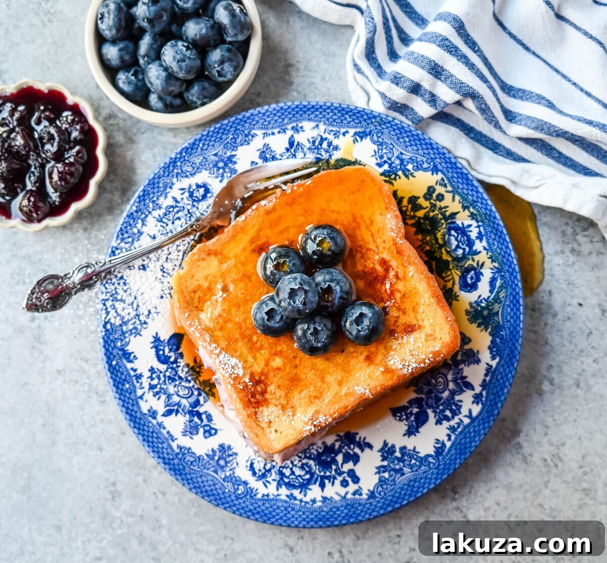 Decadent Blueberry Cheesecake French Toast 7 Gourmet Blueberry Cheesecake Stuffed French Toast topped with compote and whipped cream.