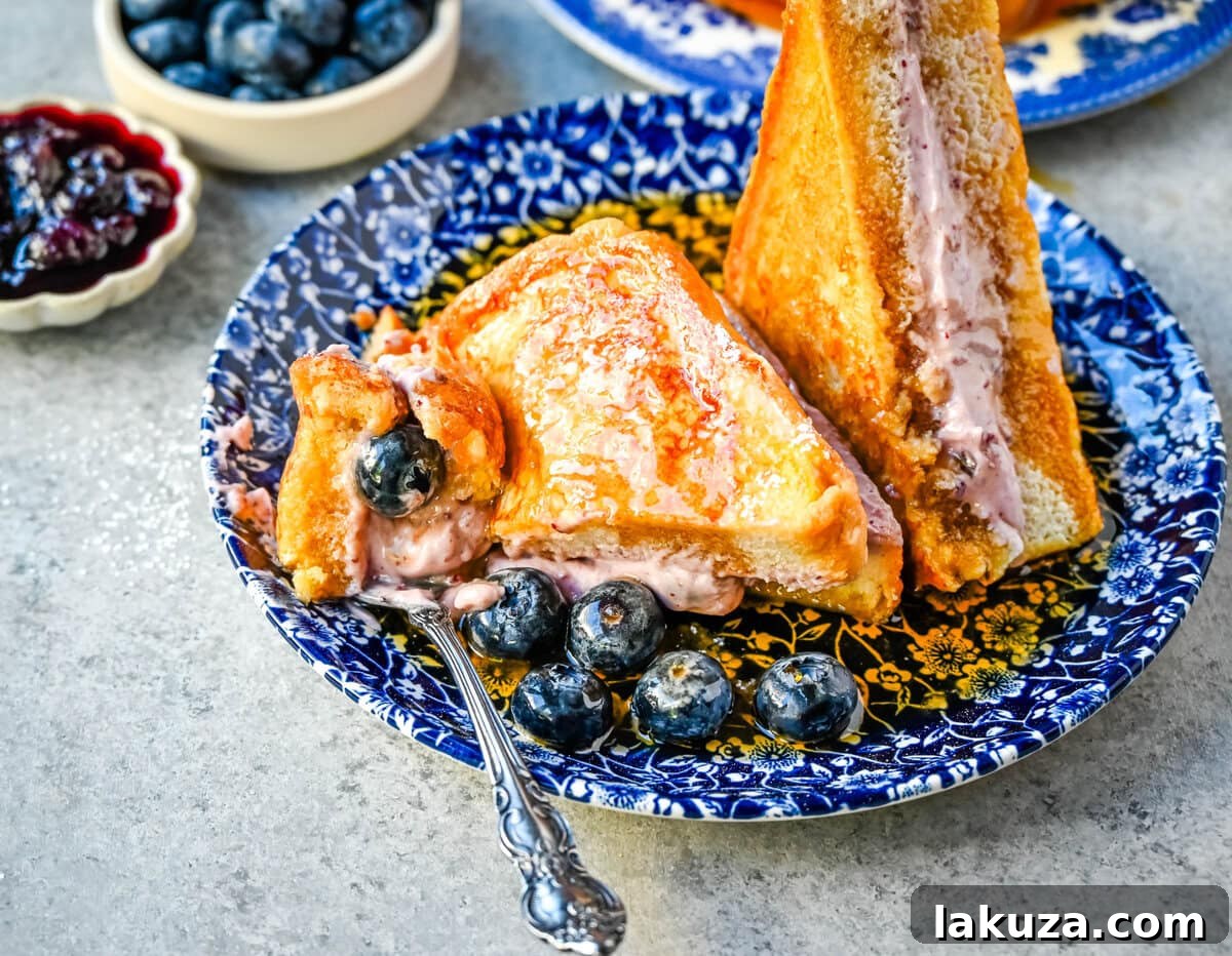 Decadent Blueberry Cheesecake French Toast 8 A stack of beautifully cooked Blueberry Cheesecake Stuffed French Toast.