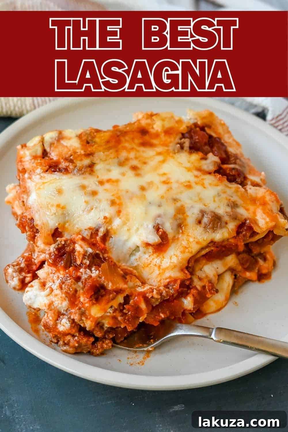 A large, perfectly cooked Italian Bolognese Lasagna, layered with creamy bechamel, savory bolognese, and melted cheese, ready to be sliced.