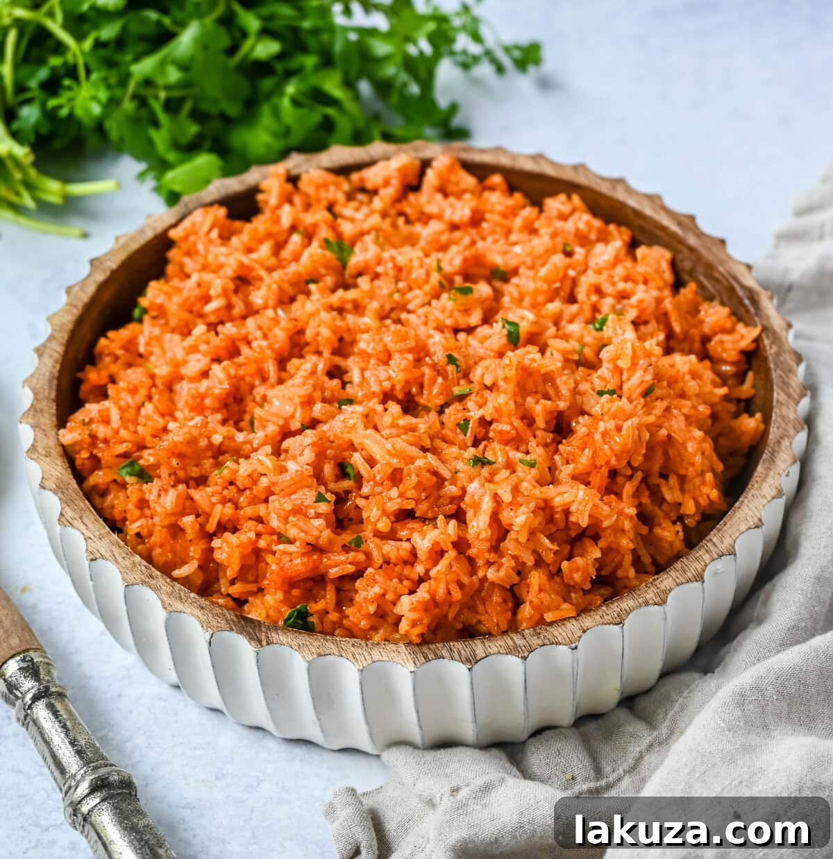 A vibrant platter featuring Spanish Rice as a side, accompanied by various Mexican dishes like tacos and enchiladas.