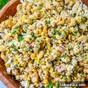 This Mexican Street Corn Pasta Salad is made with fresh corn, pasta, red onion, jalapeno, fresh cilantro, all tossed in a perfectly spiced dressing and topped with cotija cheese, Mexican spices, and fresh lime. It’s street food meets comfort food and it is so addictive. Perfect for a summer BBQ, potluck dish, or the perfect side dish, this Mexican Street Corn Pasta Salad delivers every time.