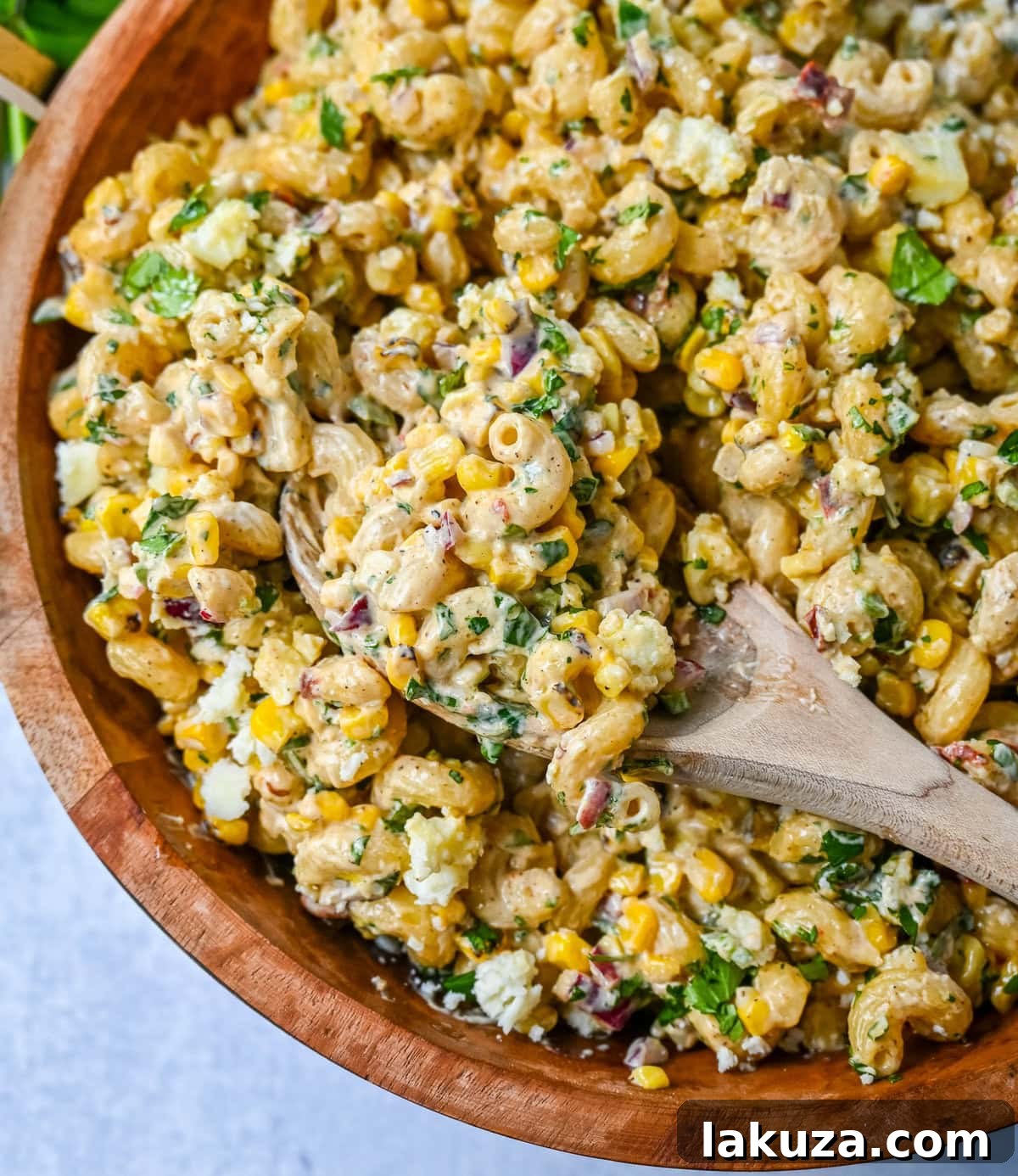 This Mexican Street Corn Pasta Salad is made with fresh corn, pasta, red onion, jalapeno, fresh cilantro, all tossed in a perfectly spiced dressing and topped with cotija cheese, Mexican spices, and fresh lime. It’s street food meets comfort food and it is so addictive. Perfect for a summer BBQ, potluck dish, or the perfect side dish, this Mexican Street Corn Pasta Salad delivers every time.
