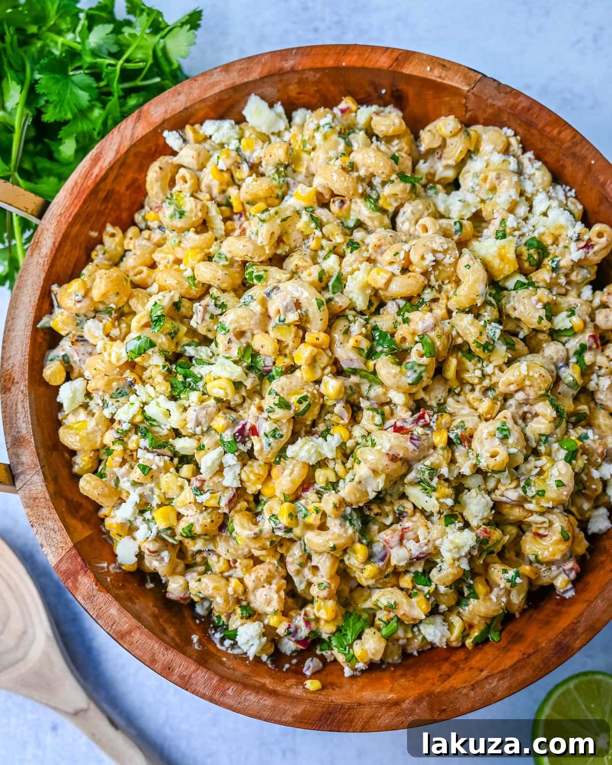 This Mexican Street Corn Pasta Salad is made with fresh corn, pasta, red onion, jalapeno, fresh cilantro, all tossed in a perfectly spiced dressing and topped with cotija cheese, Mexican spices, and fresh lime. It’s street food meets comfort food and it is so addictive. Perfect for a summer BBQ, potluck dish, or the perfect side dish, this Mexican Street Corn Pasta Salad delivers every time.