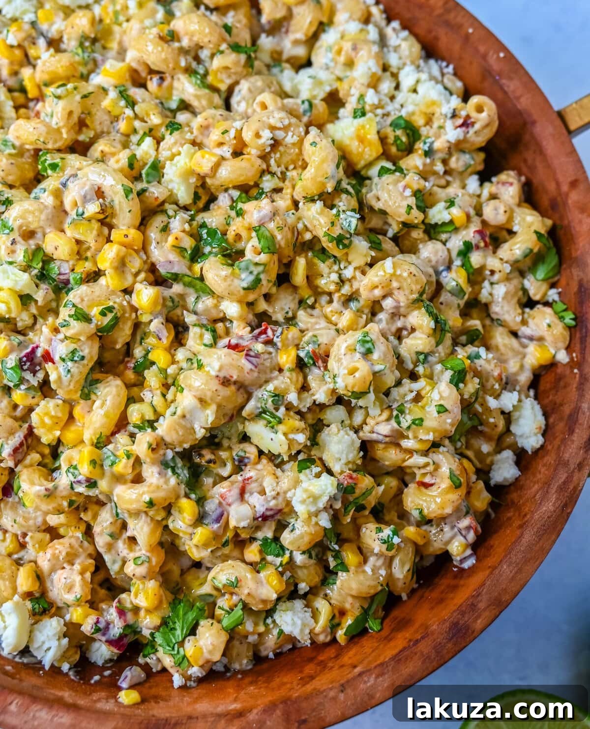 This Mexican Street Corn Pasta Salad is made with fresh corn, pasta, red onion, jalapeno, fresh cilantro, all tossed in a perfectly spiced dressing and topped with cotija cheese, Mexican spices, and fresh lime. It’s street food meets comfort food and it is so addictive. Perfect for a summer BBQ, potluck dish, or the perfect side dish, this Mexican Street Corn Pasta Salad delivers every time.