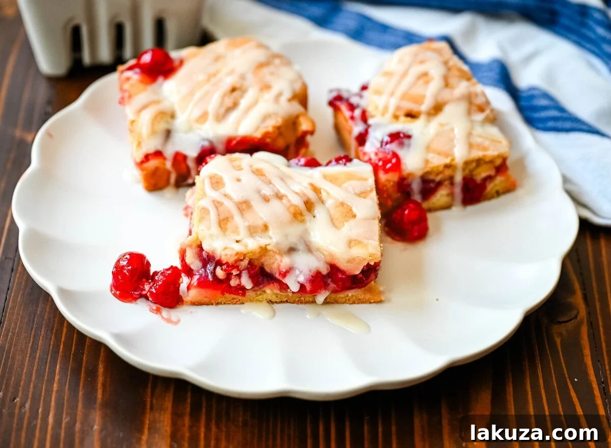 Close-up of Cherry Pie Bars, showcasing the cookie crust, vibrant cherry filling, and golden crumble topping.