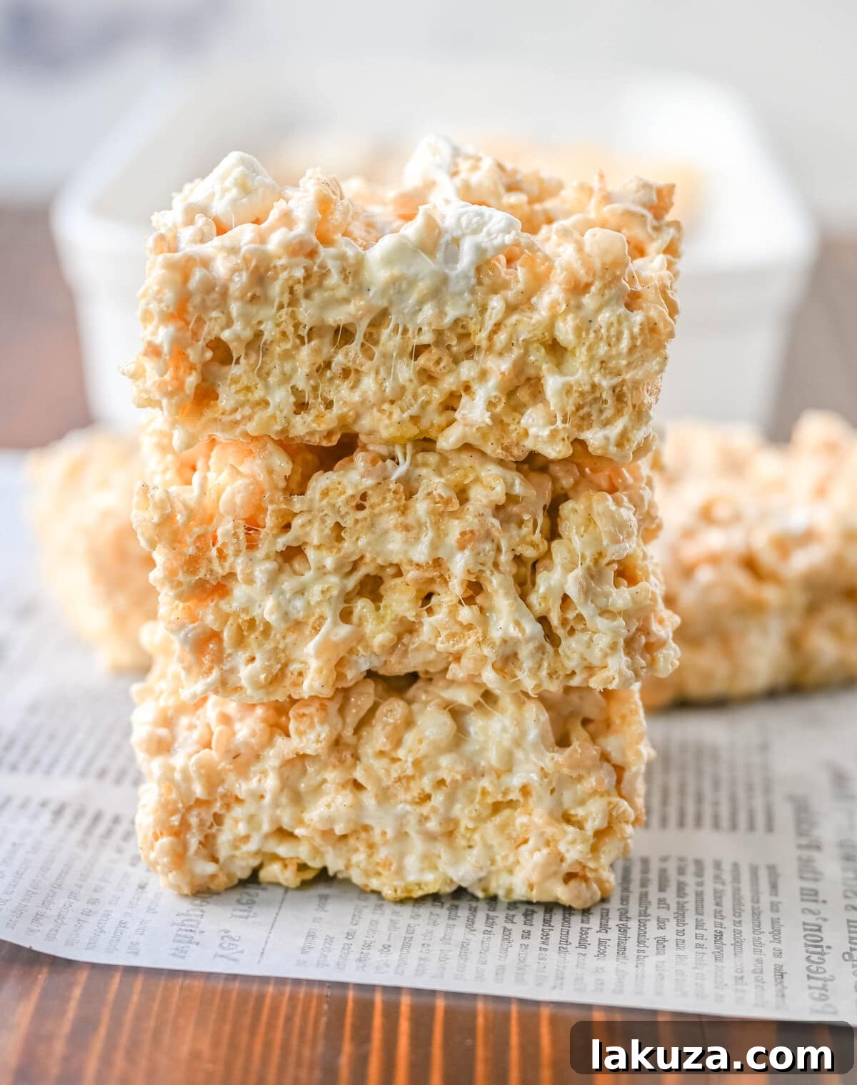 Nutty Brown Butter Crispy Bars 6 Beautifully cut squares of Brown Butter Rice Krispies Treats, showcasing their irresistible golden-brown hue and perfectly gooey texture, ready to be enjoyed.