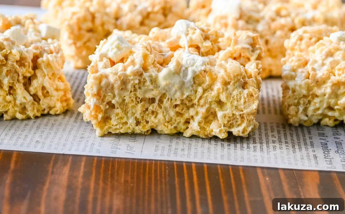 Nutty Brown Butter Crispy Bars 7 A close-up shot of the irresistible gooeyness of Brown Butter Rice Krispies Treats, highlighting the perfect marshmallow-to-cereal ratio and the golden-brown crust.