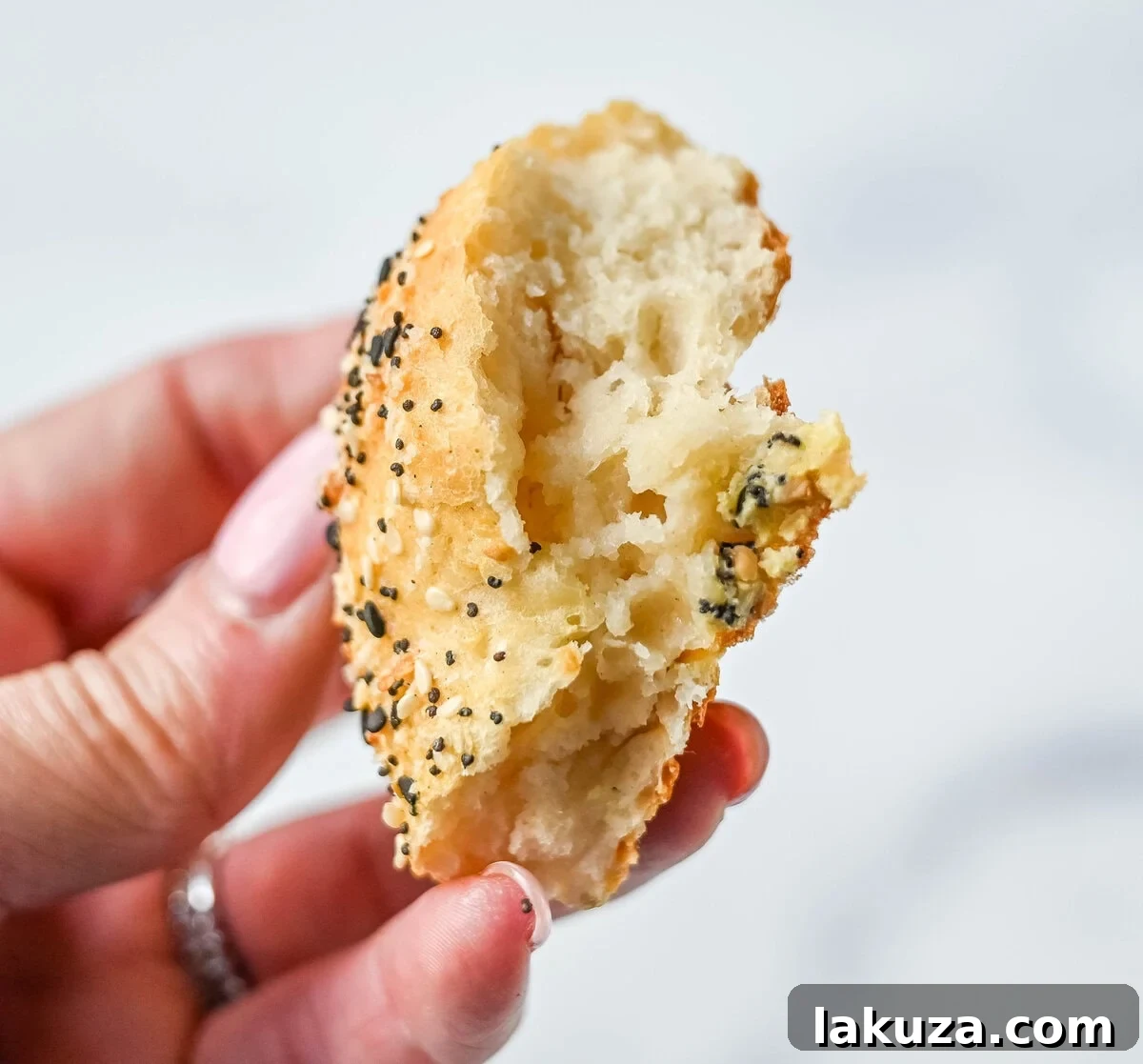 Close-up of a freshly sliced cottage cheese bagel, ready to be topped