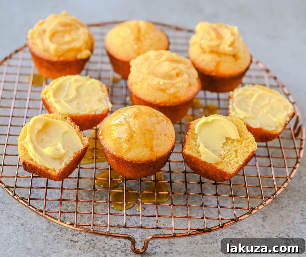 Buttery Cornbread Muffins 3 Close-up view of golden brown corn muffins, showcasing their perfectly domed tops and tender, crumbly texture.