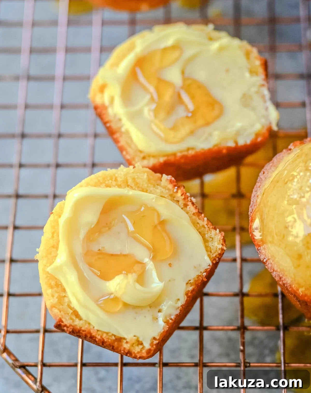 Buttery Cornbread Muffins 4 A bowl of freshly prepared corn muffin batter, thick and golden, ready to be poured into a muffin tin, with ingredients like cornmeal and butter visible on the side.
