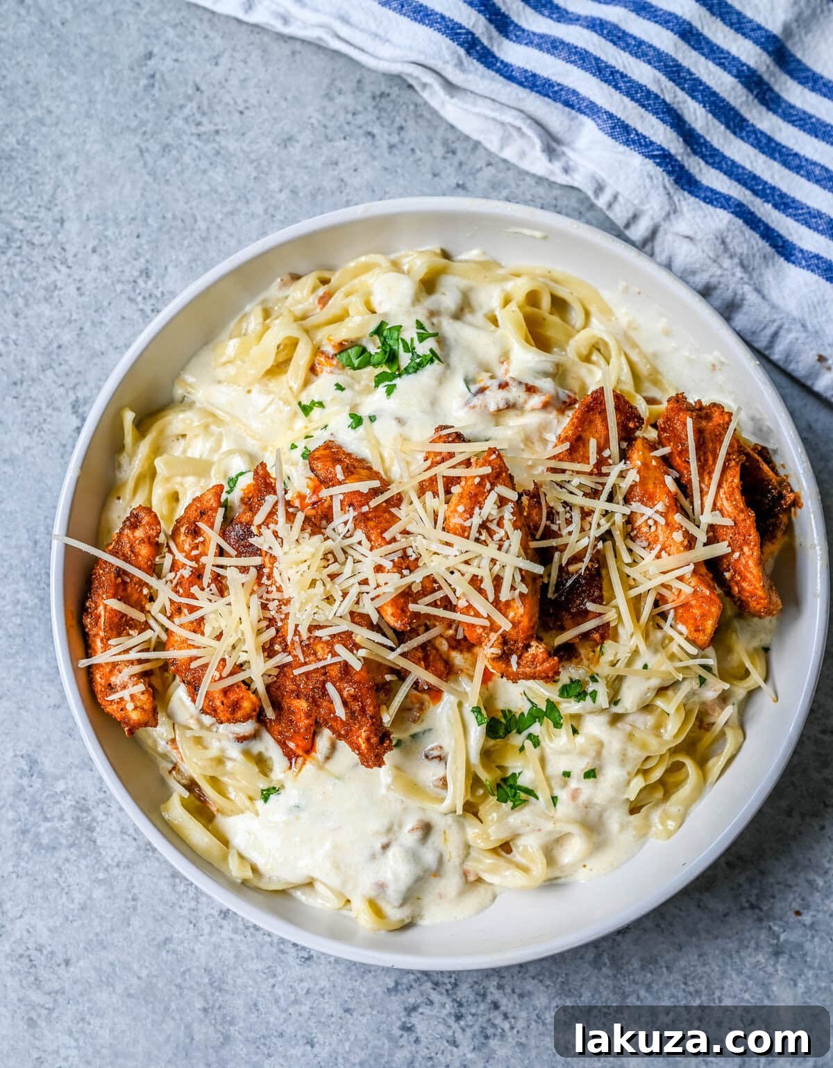 Creamy Cajun Chicken Alfredo 4 Cajun Chicken Alfredo is the ultimate comfort food with a spicy twist — tender blackened chicken, tossed in a silky Parmesan cream sauce over perfectly cooked pasta. Whether you're cooking for a weeknight dinner or a crowd, this dish delivers big time in flavor.
