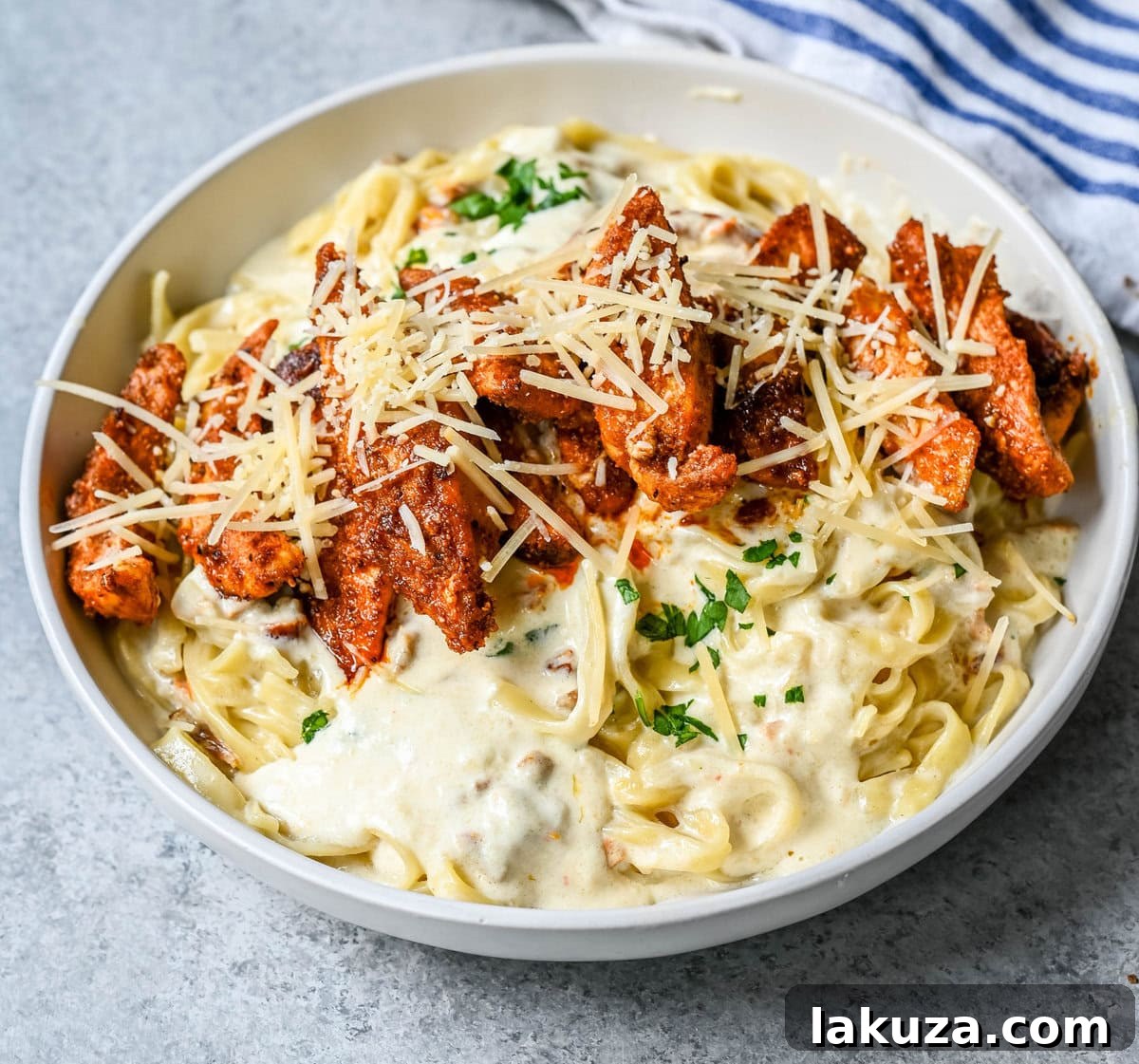 Creamy Cajun Chicken Alfredo 5 Cajun Chicken Alfredo is the ultimate comfort food with a spicy twist — tender blackened chicken, tossed in a silky Parmesan cream sauce over perfectly cooked pasta. Whether you're cooking for a weeknight dinner or a crowd, this dish delivers big time in flavor.
