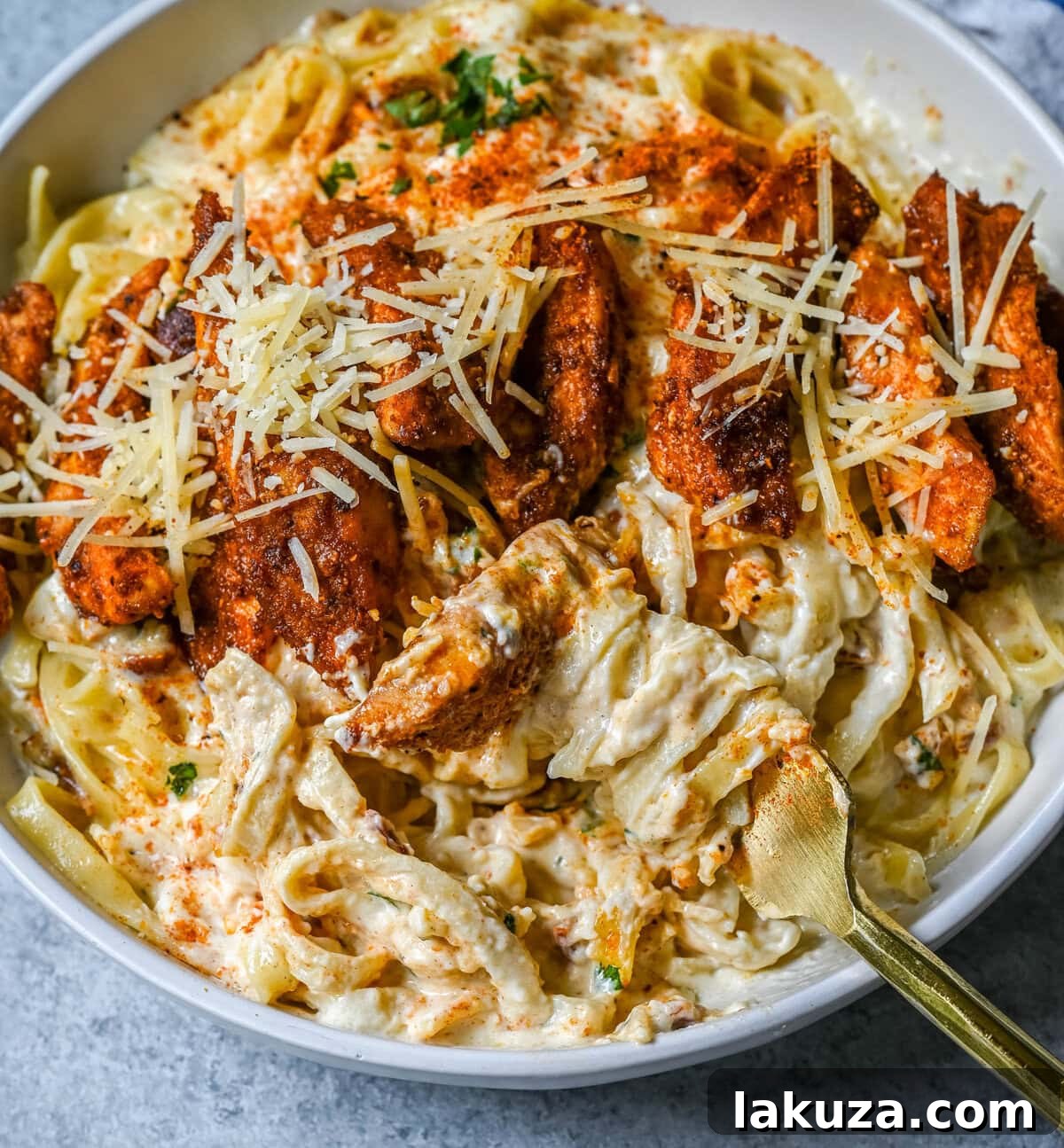 Creamy Cajun Chicken Alfredo 6 Cajun Chicken Alfredo is the ultimate comfort food with a spicy twist — tender blackened chicken, tossed in a silky Parmesan cream sauce over perfectly cooked pasta. Whether you're cooking for a weeknight dinner or a crowd, this dish delivers big time in flavor.