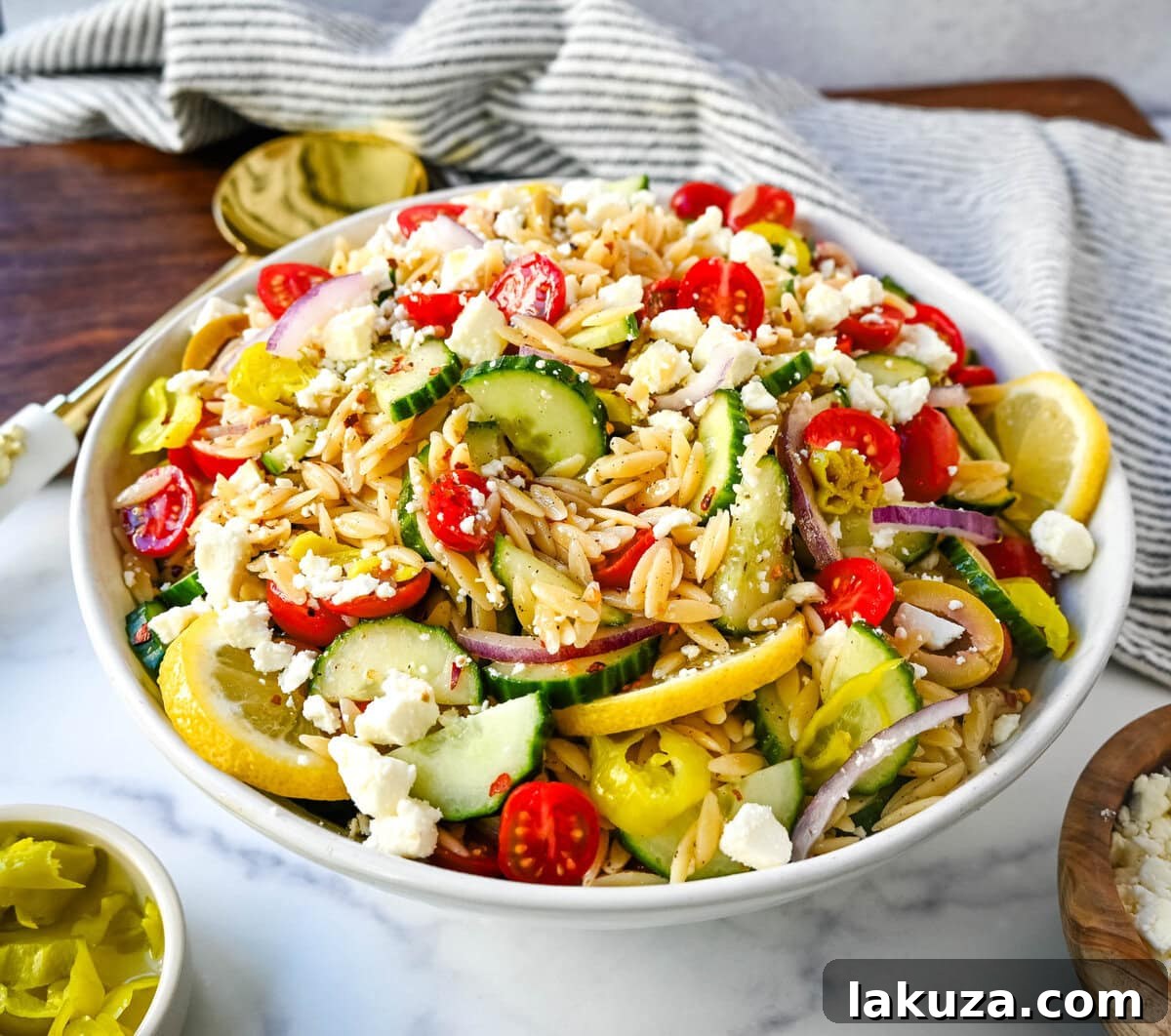 Fresh Mediterranean Orzo Salad made with a bright greek oregano dressing, orzo pasta, crisp cucumber, cherry tomatoes, red onion, feta cheese, and pepperoncinis. This greek orzo pasta salad recipe is perfect for summer or meal prep!