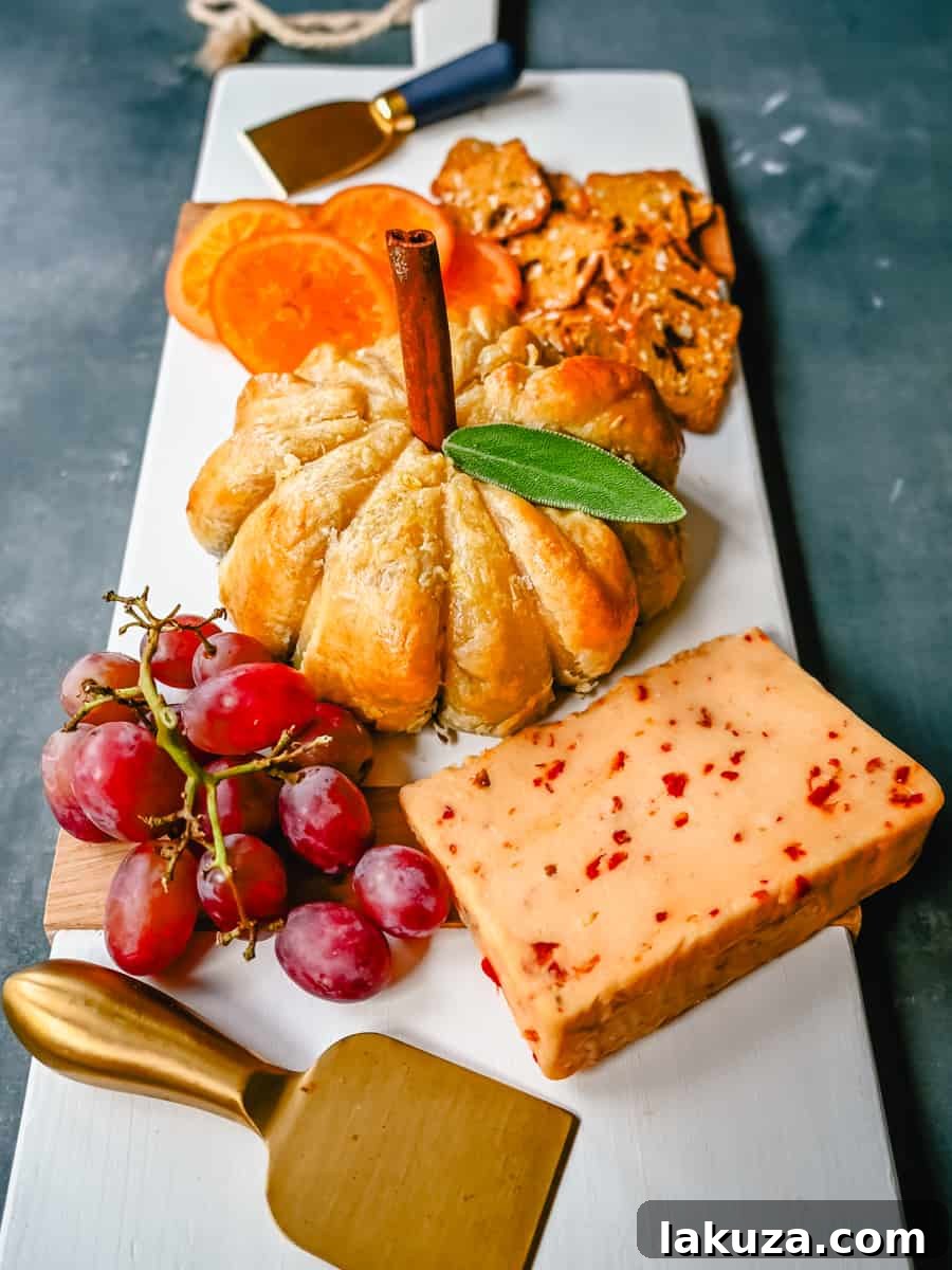 Pumpkin Shaped Baked Brie Puff Pastry. This festive Fall Pumpkin Baked Brie is the perfect appetizer or centerpiece for your charcuterie board. Flaky puff pastry baked with creamy brie cheese and pumpkin butter or fig jam is the perfect salty sweet combination.