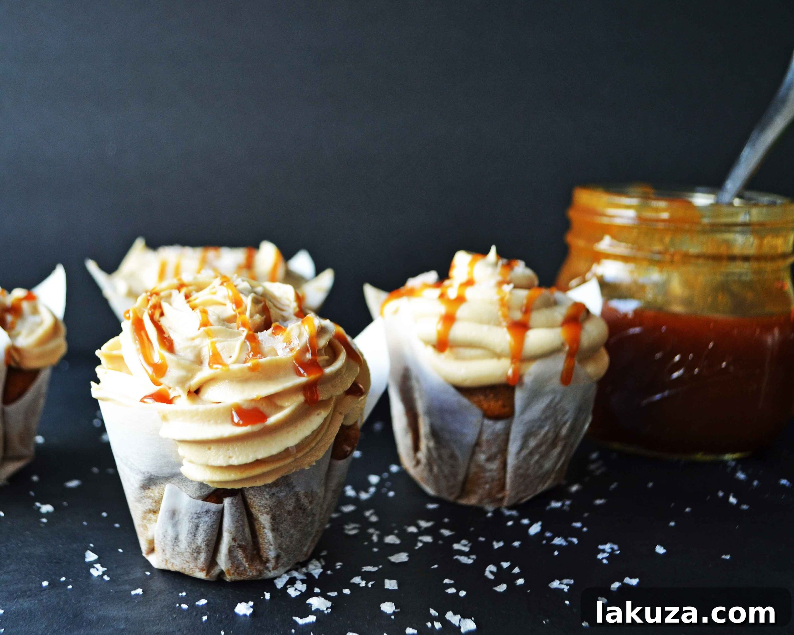 Pumpkin Cupcakes with Salted Caramel Frosting by Modern Honey. Homemade, made from scratch salted carmel frosting tops a cinnamon spiced pumpkin cupcake. The perfect Fall dessert! www.modernhoney.com