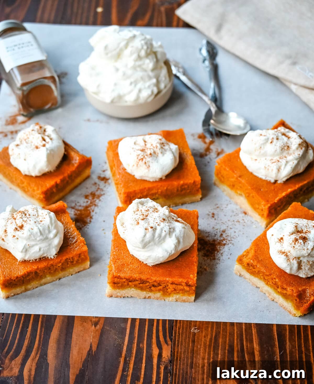 These homemade Pumpkin Pie Bars are made with a buttery shortbread crust and topped with a creamy pumpkin cream cheese filling and baked. These easy pumpkin pie bars are topped with fresh whipped cream and cut into squares for an easy alternative to pumpkin pie.