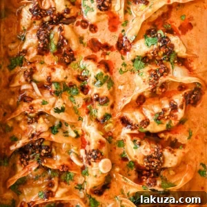 These viral baked dumplings from TikTok are the ultimate easy dinner hack! Crispy dumplings are baked in a creamy coconut curry sauce and topped with cilantro, chili crunch oil, and sesame seeds for the perfect mix of flavor and texture. This is an easy sheet pan dinner recipe!
